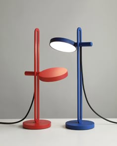 two different colored lamps sitting next to each other