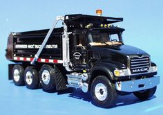 a black dump truck on a blue background
