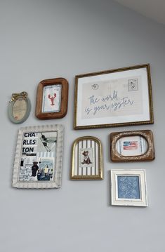 there are many different framed pictures on the wall next to each other, including one with an envelope