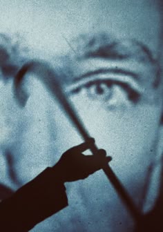 a man holding a knife in front of his face