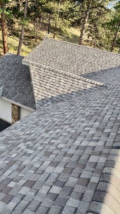 the roof of a house with two garages and trees in the background