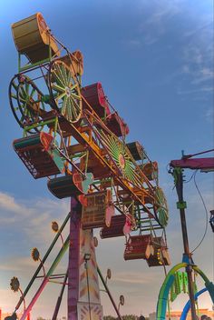 an amusement park ride that is very colorful and has lots of rides on top of it