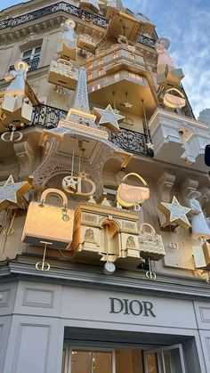 a very tall building with lots of decorations on it's side and the words dior written in gold