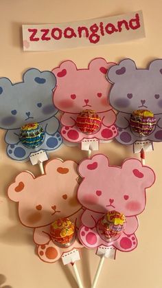 several lollipops shaped like teddy bears on sticks