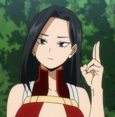 an anime character with long black hair pointing to the side and trees in the background