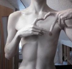 a man with his hands on his chest