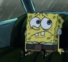 spongebob is sitting in the back seat of a car with his eyes wide open