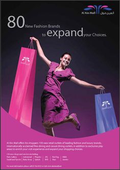 a woman in purple dress holding shopping bags