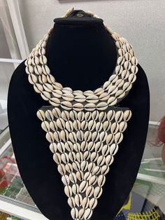 Cowrie shell necklace made with shells and leather. Thanks for visiting my shop.  Come again. Stay safe.   https://www.etsy.com/shop/naistumityujewelry Elegant Festival Jewelry With Unique Design, Unique Shell Beaded Necklaces For Beach, Unique Shell Necklaces, Handmade White Shell Beaded Necklaces, Beaded Cowrie Shell Jewelry, White Shell Necklaces For Festivals, Handmade White Shell Necklaces, White Shell Necklaces For Festival, Elegant Mother Of Pearl Beaded Necklaces For Beach