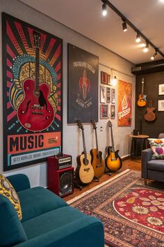 a living room with guitars on the wall, couches and rugs in front of them