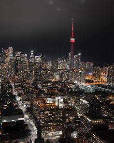 an aerial view of the city at night with bright lights and skyscrapers in the background