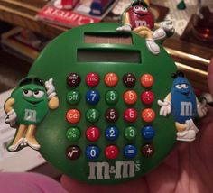 a green calculator with characters on it