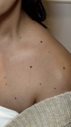 a woman with small black dots on her chest