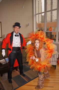a man and woman dressed in costumes standing next to each other on a wooden floor