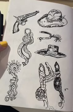 a person is holding a book with drawings on it and pointing to the page in front of them