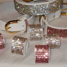 a white belt with pink and gold sequins on it, along with matching belts
