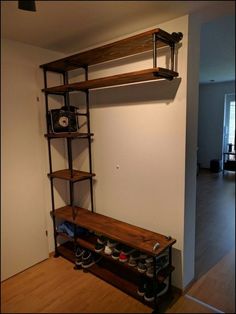 an empty room with shelves and shoes on the floor