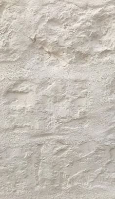 a white stucco wall textured with cement