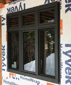 an image of a window being installed on the side of a house that is under construction