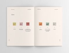an open book with different colored squares on the cover and inside pages in white paper