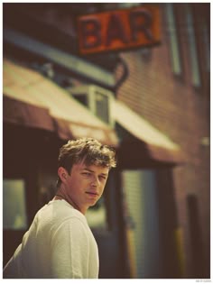 a man standing in front of a bar