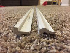 there are two pieces of metal on the carpet in this room, one is white and the other is gray