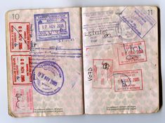 an open passport book with stamps on it