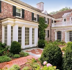 a large brick house with white trim and windows