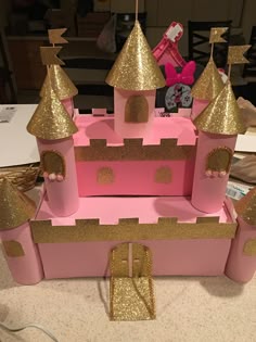 a pink and gold castle made out of cardboard