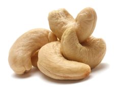 peeled cashews are piled on top of each other to be used as an ad