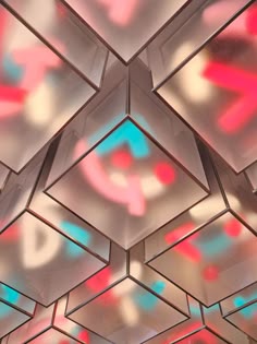 the ceiling is made up of many square shapes with colored lights on them and there are no people in the room