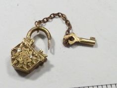 an antique lock and key on a chain