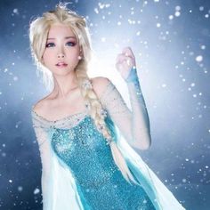 a woman dressed in an ice princess costume with long blonde hair and flowing blue dress