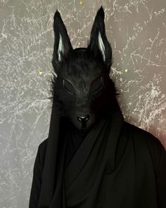 a person in a black suit with a cat's head on top of their head