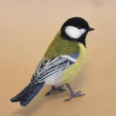 a small toy bird sitting on top of a table