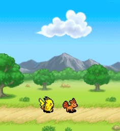 an animal crossing a dirt road with trees and mountains in the background