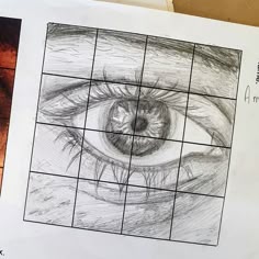 a drawing of an eye is shown in the middle of a piece of white paper
