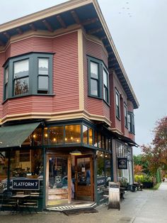 a red building with black trim and windows