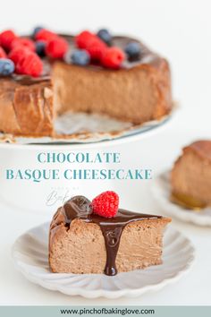 a chocolate cheesecake with raspberries and chocolate sauce on top, sitting on a white plate