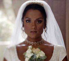 a woman in a wedding dress holding a bouquet