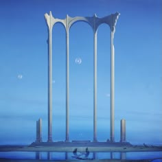 an image of three tall pillars in the sky with water below them and moon above