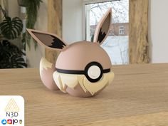 a pokemon ball sitting on top of a wooden table