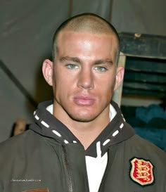 a man with a bald head wearing a jacket