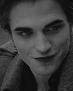 a man with red eyes and vampire makeup