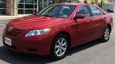 a red car parked in front of a building