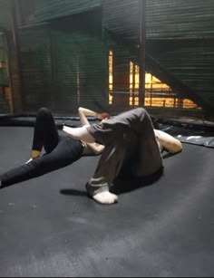 a woman laying on top of a trampoline with her legs spread out in the air