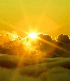 the sun is setting over some clouds