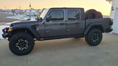 a gray jeep parked in front of a house