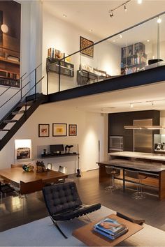 a living room filled with furniture and a stair case