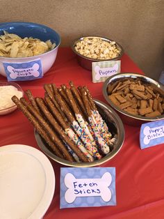 dog treats and snacks are on the table for dogs to eat at their birthday party